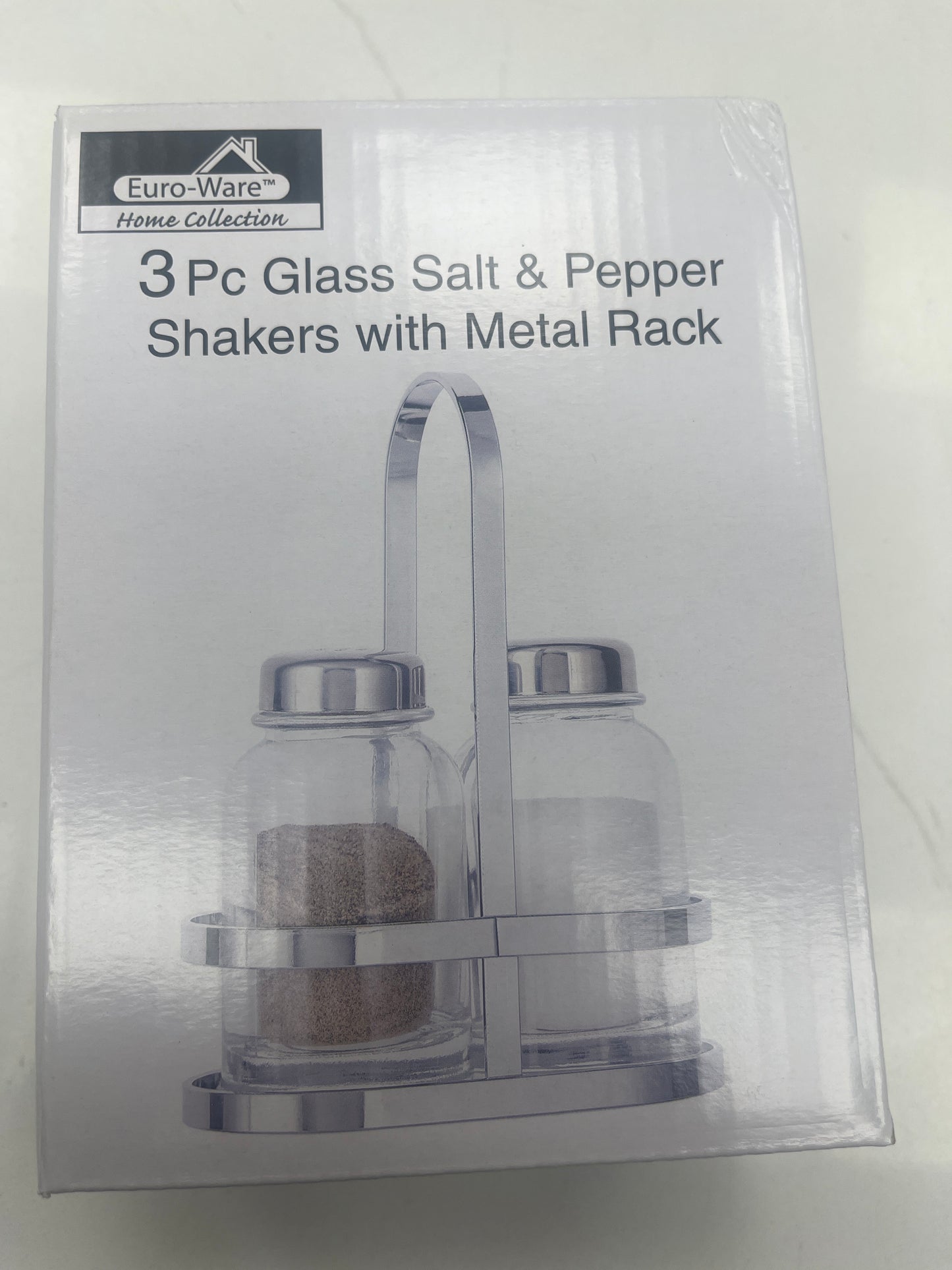 Glass salt and pepper shaker with metal rack
